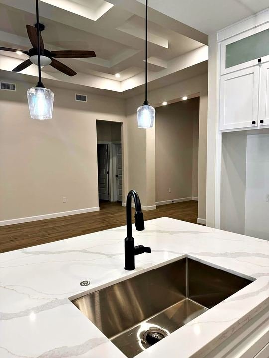 Kitchen remodel with white shaker cabinets and quartz countertops