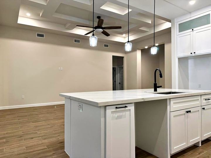 Kitchen remodel with white shaker cabinets and quartz countertops
