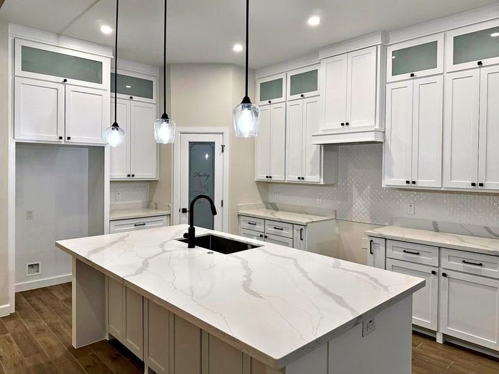 Kitchen remodel with white shaker cabinets and quartz countertops
