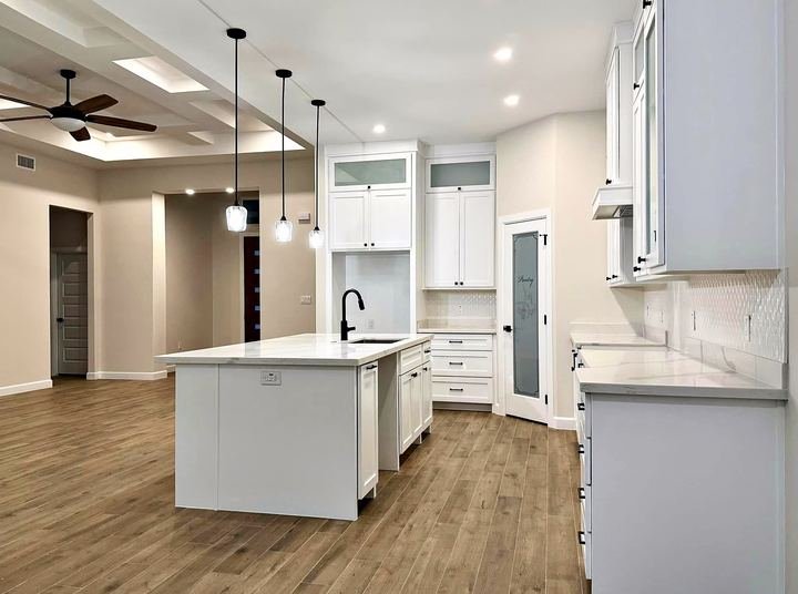Kitchen remodel with white shaker cabinets and quartz countertops