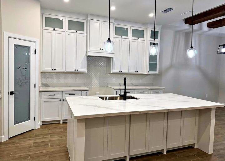 Kitchen remodel with white shaker cabinets and quartz countertops