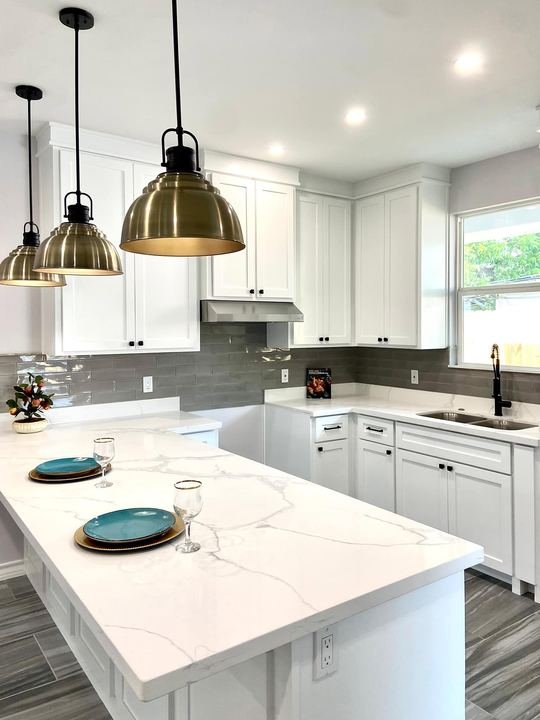 Kitchen remodel with white shaker cabinets and quartz countertops