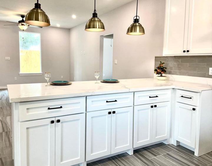 Kitchen remodel with white shaker cabinets and quartz countertops